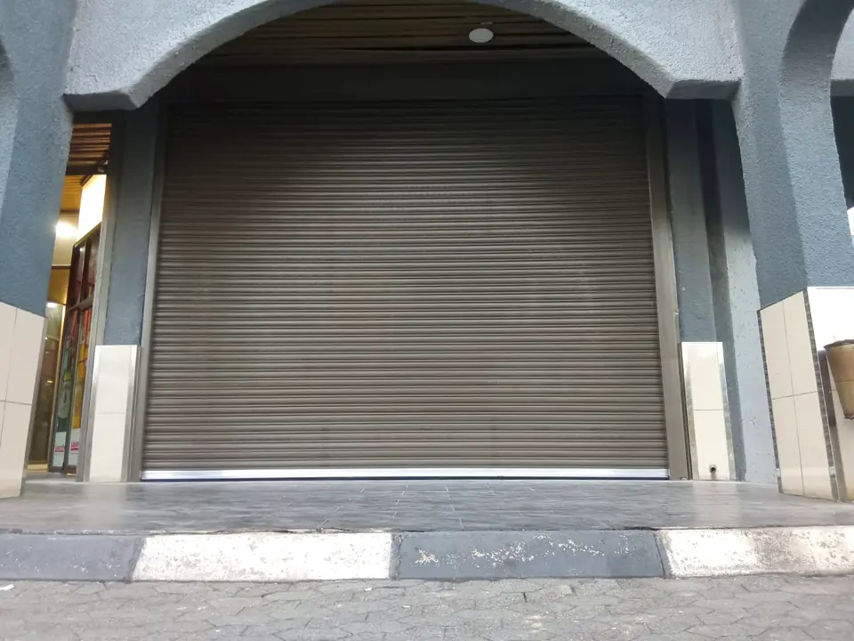 Roller shutter fitted under an arched retail entrance