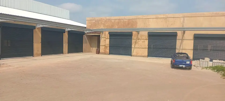 Commercial complex with charcoal roller doors on each unit