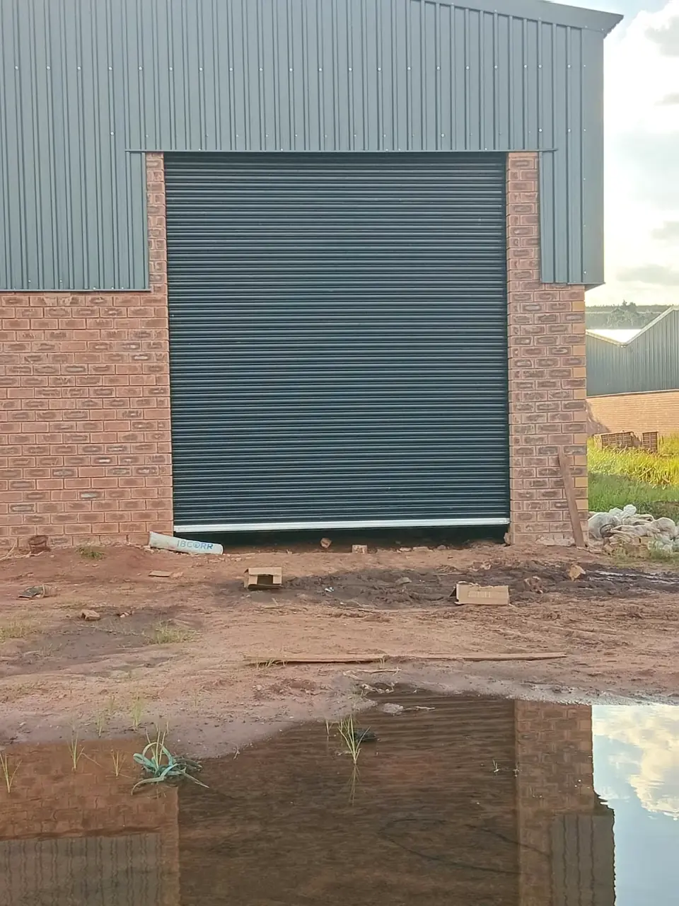 Charcoal roller door on a new brick industrial unit
