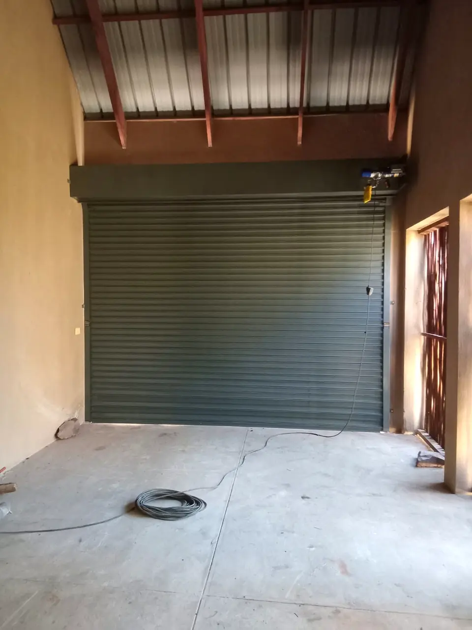 Charcoal roller door in a new workshop